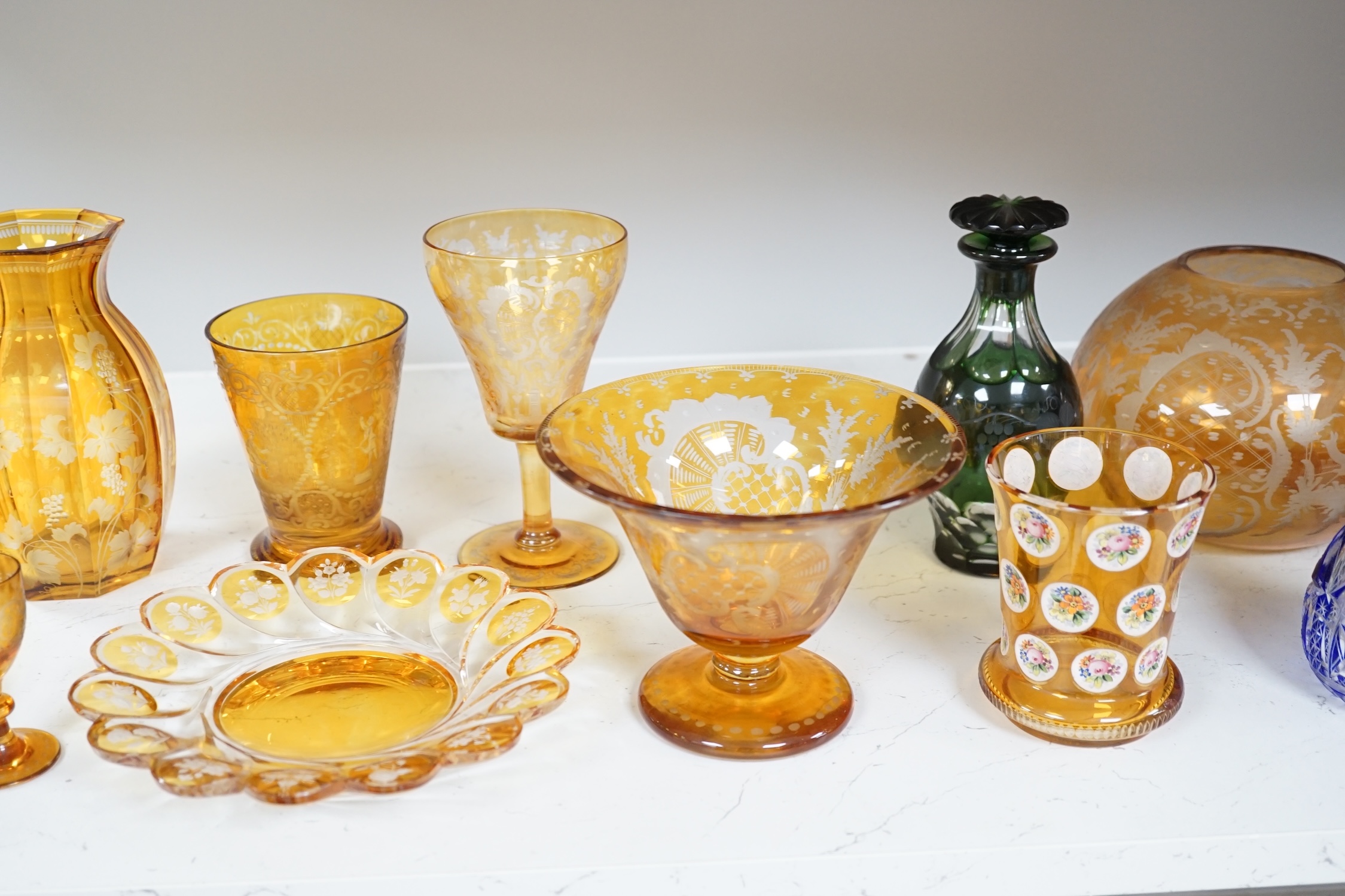 A collection of mostly Bohemian amber flashed cut glassware to include dishes, glasses and a silver topped atomiser, largest 22cm in diameter. Condition - mostly fair